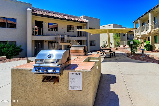 exterior space featuring a grill and stairway