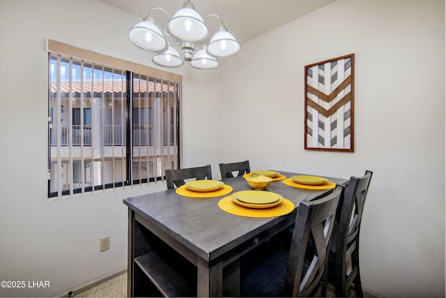 dining room with a notable chandelier and baseboards