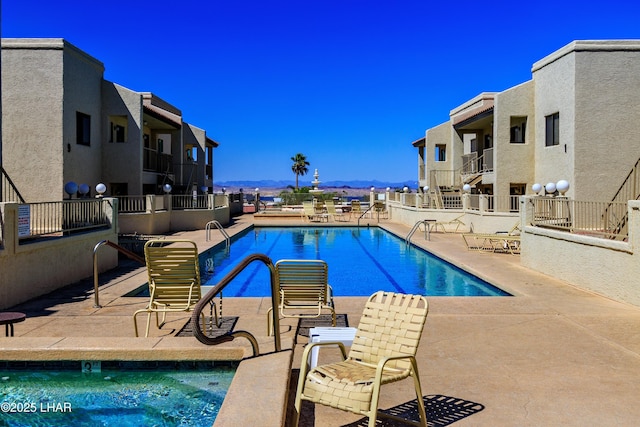 pool with a patio and a mountain view