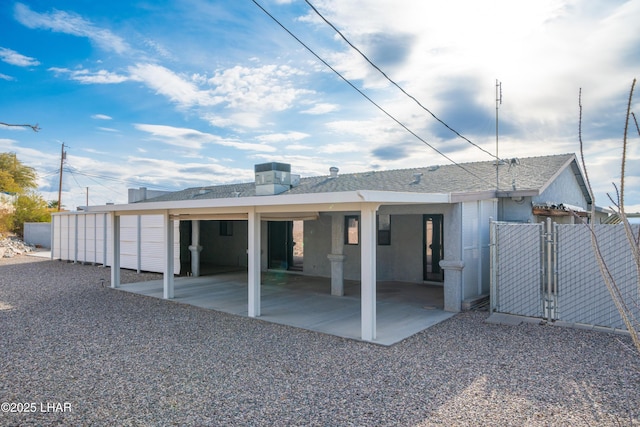 rear view of property with a carport