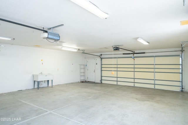 garage featuring a garage door opener and sink