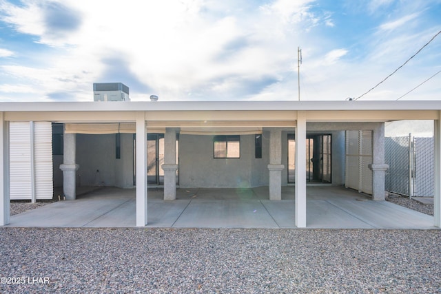 rear view of property with a carport and central AC unit