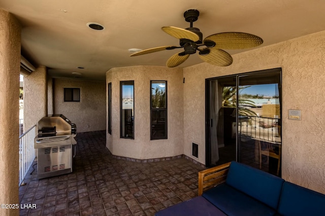 view of patio / terrace featuring a grill and a ceiling fan