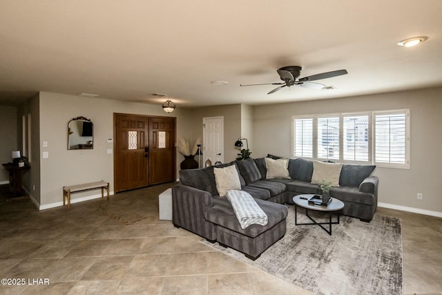 living room with light tile patterned floors, ceiling fan, visible vents, and baseboards