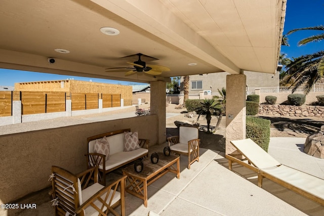 view of patio with a fenced backyard, an outdoor living space, and a ceiling fan