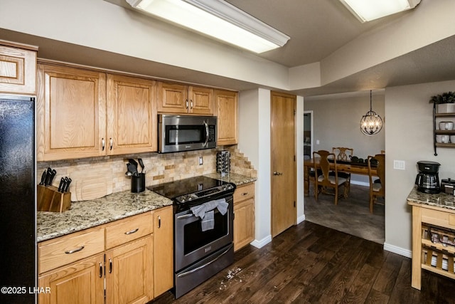 kitchen featuring baseboards, appliances with stainless steel finishes, decorative backsplash, light stone countertops, and dark wood-style floors