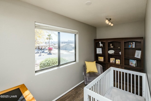 bedroom with wood finished floors and baseboards