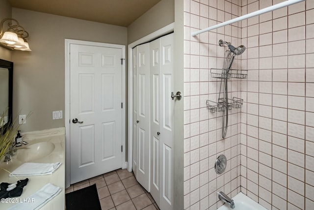 bathroom featuring  shower combination, vanity, and tile patterned floors