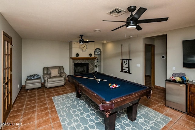 playroom featuring billiards, visible vents, a ceiling fan, a tile fireplace, and tile patterned floors