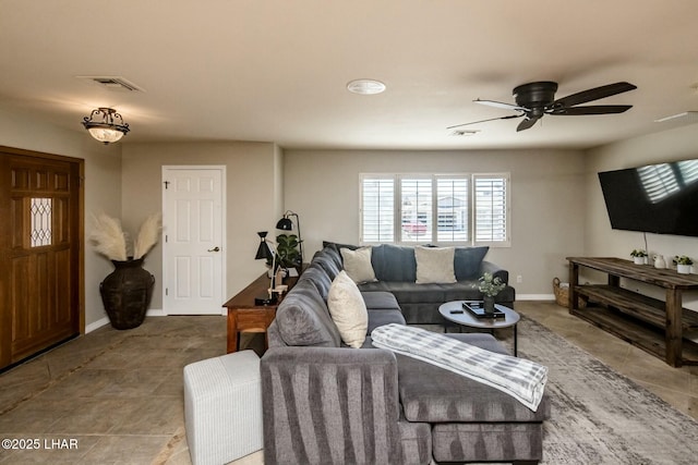 tiled living room with visible vents, ceiling fan, and baseboards