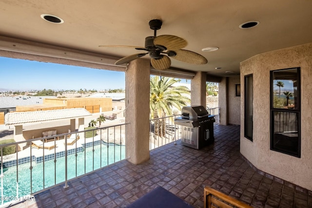 view of patio / terrace featuring a ceiling fan, a fenced in pool, a grill, and a balcony