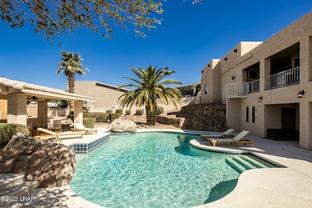 outdoor pool with a patio area