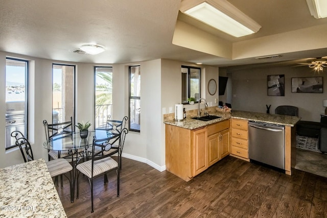 kitchen with baseboards, dishwasher, dark wood-style floors, light brown cabinets, and a sink