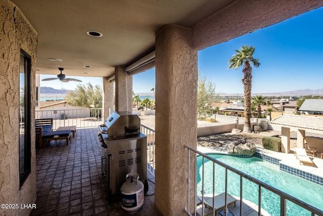 view of patio with a ceiling fan, a fenced in pool, a grill, fence, and a mountain view