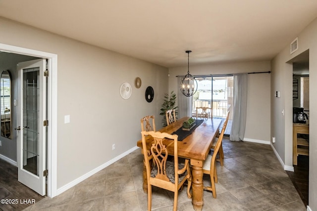 dining space featuring an inviting chandelier, baseboards, and visible vents