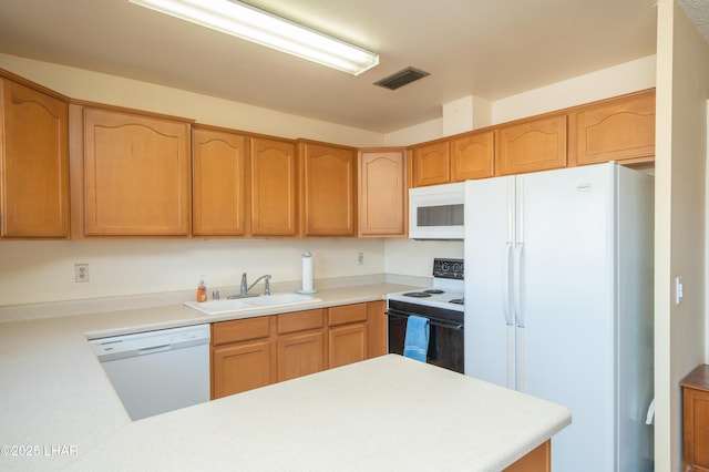 kitchen featuring white appliances, visible vents, light countertops, and a sink