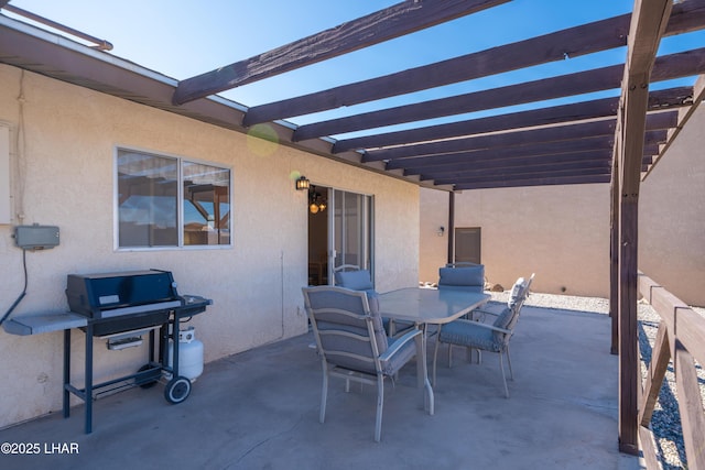 view of patio with outdoor dining area, electric panel, and a pergola