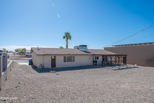 rear view of house featuring a patio area, cooling unit, and stucco siding