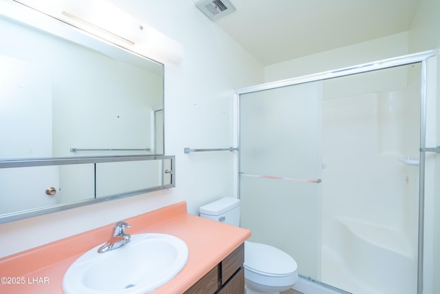 full bathroom with toilet, a stall shower, vanity, and visible vents