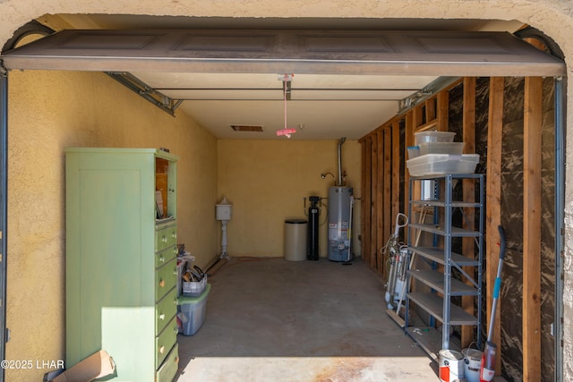 garage featuring gas water heater and visible vents