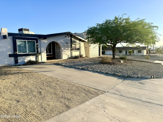 view of front facade featuring a garage and central AC unit