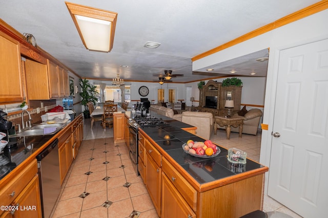 kitchen featuring light tile patterned flooring, sink, a center island, tile counters, and stainless steel appliances