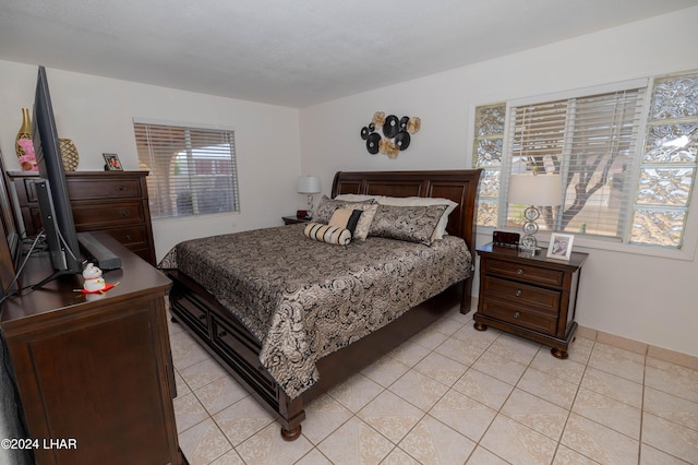 tiled bedroom with multiple windows