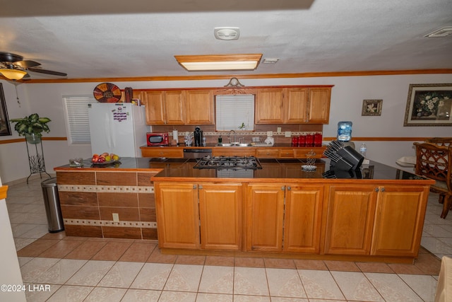 kitchen featuring sink, light tile patterned floors, stainless steel dishwasher, white fridge, and ceiling fan