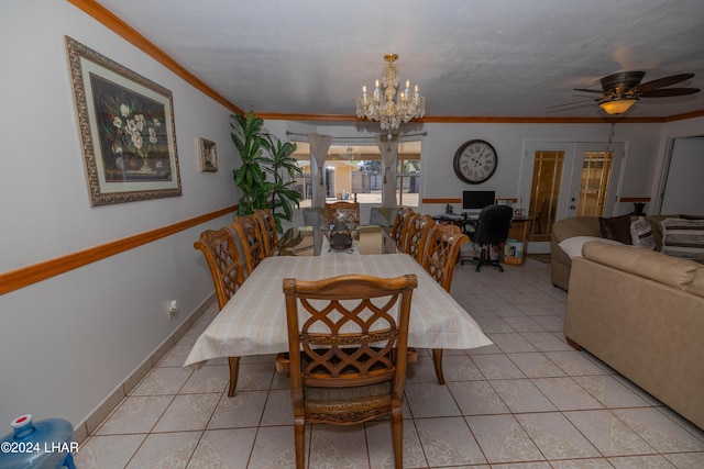 tiled dining room with crown molding, ceiling fan with notable chandelier, and french doors