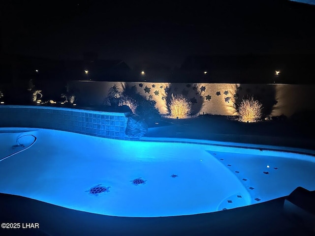 view of pool at night