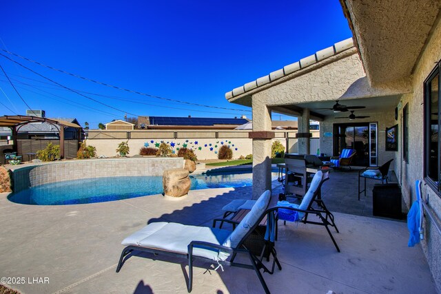 view of pool with a patio area and ceiling fan