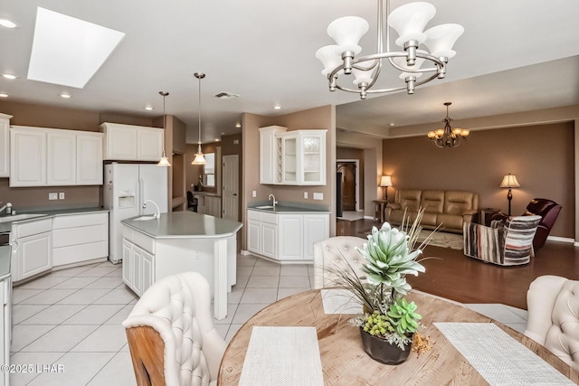 dining area featuring visible vents, recessed lighting, a chandelier, a skylight, and light tile patterned floors