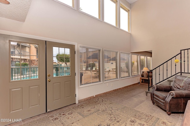 interior space with a high ceiling and plenty of natural light