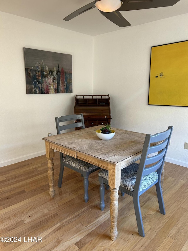 dining space with wood-type flooring and ceiling fan