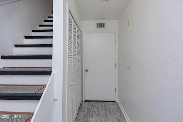 stairs featuring wood-type flooring