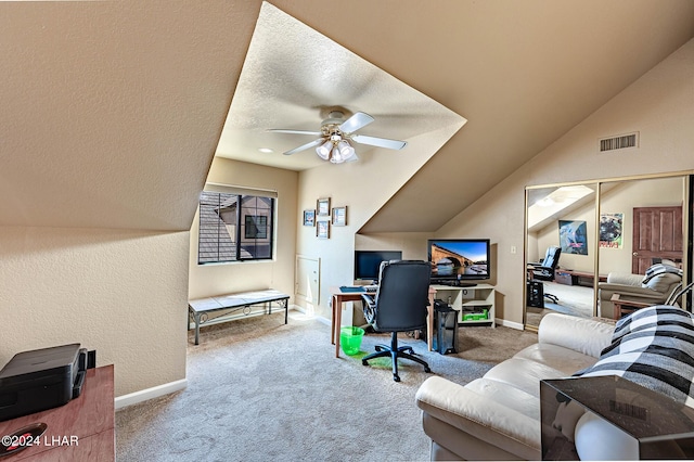 home office featuring vaulted ceiling, carpet, and ceiling fan