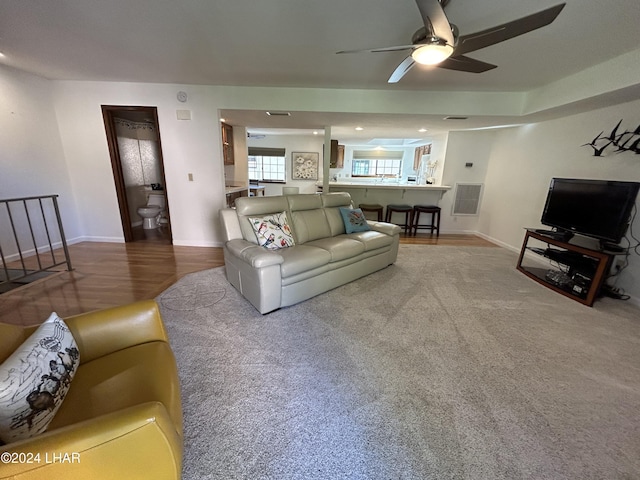 living room with hardwood / wood-style flooring and ceiling fan