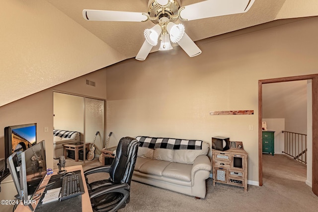 office area featuring vaulted ceiling, carpet floors, and ceiling fan