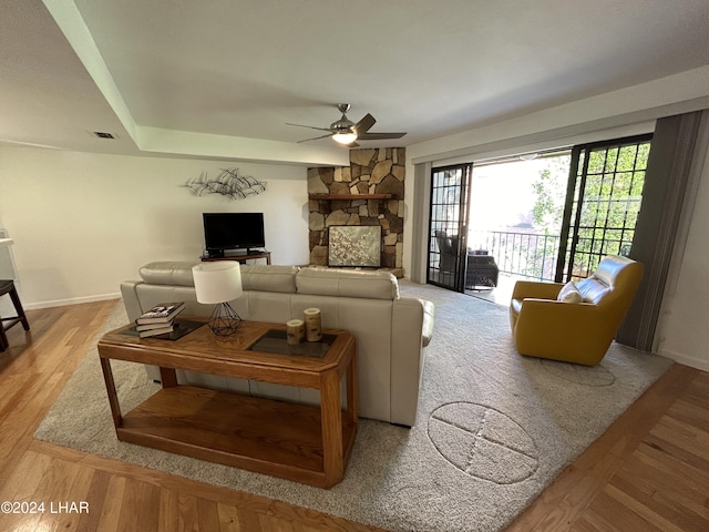 living room with ceiling fan and light hardwood / wood-style floors