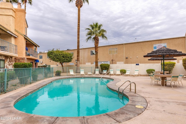 view of swimming pool with a patio