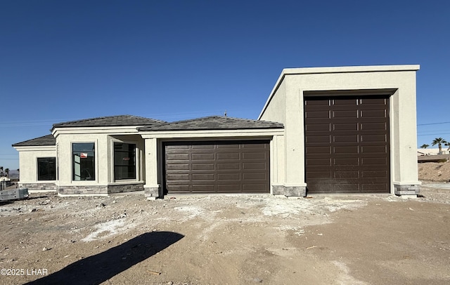 view of front of home with an attached garage and stucco siding