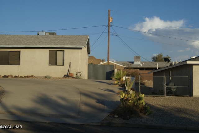 3098 Mcculloch Blvd N, Lake Havasu City, AZ 86403 - view of property exterior featuring fence, stucco siding, and a shingled roof