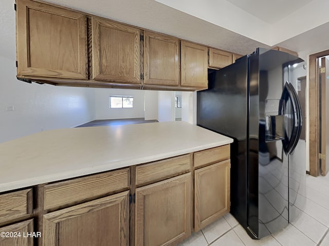 3098 Mcculloch Blvd N, Lake Havasu City, AZ 86403 - kitchen with light countertops, black refrigerator with ice dispenser, and light tile patterned flooring
