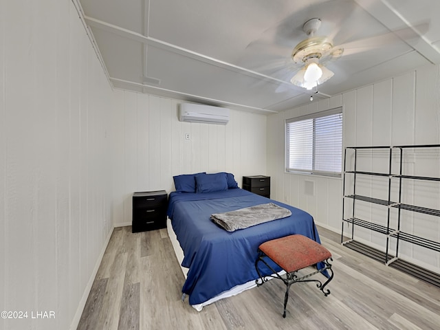 3098 Mcculloch Blvd N, Lake Havasu City, AZ 86403 - bedroom featuring ceiling fan, a wall unit AC, baseboards, and light wood finished floors