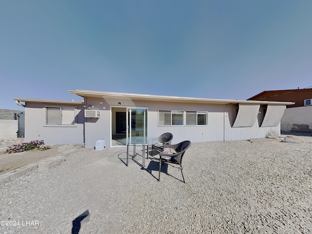 3098 Mcculloch Blvd N, Lake Havasu City, AZ 86403 - rear view of house with a wall unit AC and a patio area