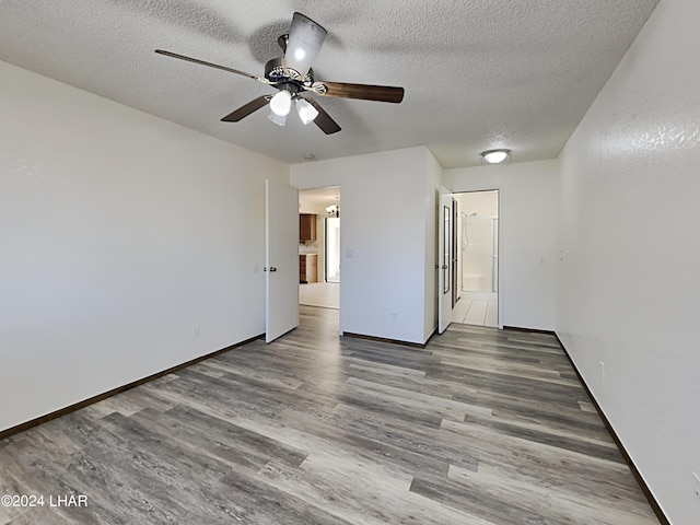 3098 Mcculloch Blvd N, Lake Havasu City, AZ 86403 - spare room with a textured ceiling, baseboards, a ceiling fan, and wood finished floors