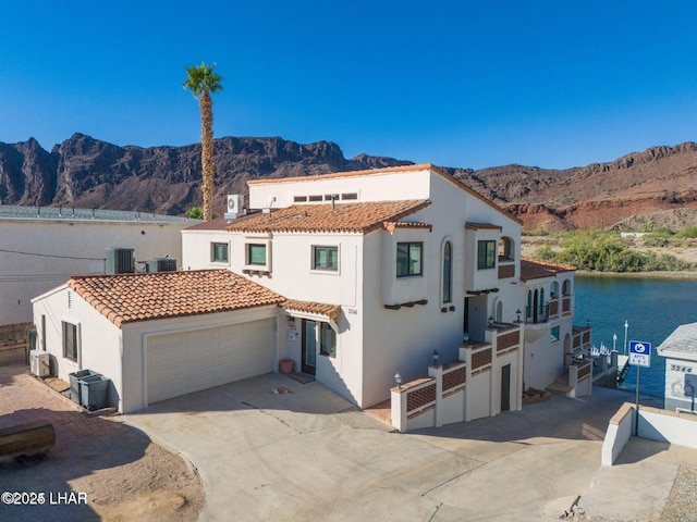 mediterranean / spanish home with a mountain view and central AC unit