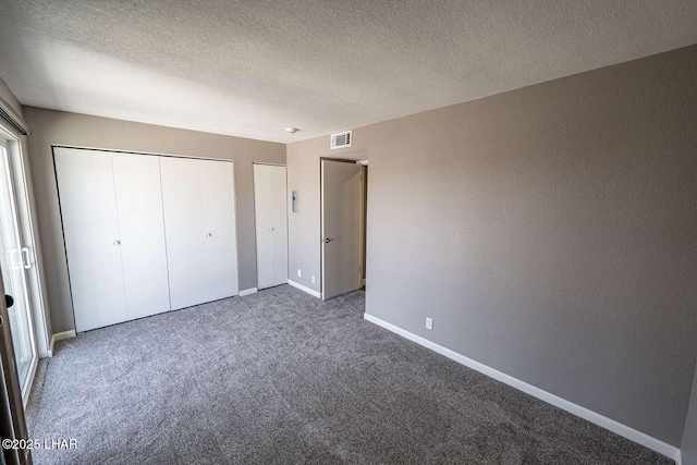 276 Lake Havasu Ave S Unit C31, Lake Havasu City, AZ 86403 - unfurnished bedroom with carpet flooring, baseboards, a textured ceiling, and a textured wall