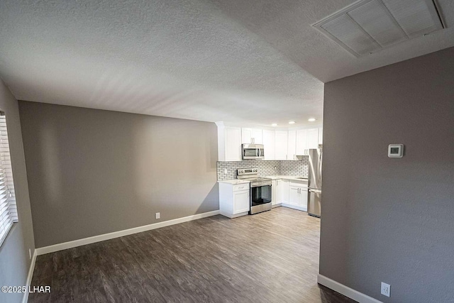 276 Lake Havasu Ave S Unit C31, Lake Havasu City, AZ 86403 - kitchen with appliances with stainless steel finishes, wood finished floors, backsplash, light countertops, and a textured ceiling
