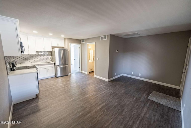 276 Lake Havasu Ave S Unit C31, Lake Havasu City, AZ 86403 - kitchen featuring appliances with stainless steel finishes, baseboards, dark wood-type flooring, tasteful backsplash, and light countertops
